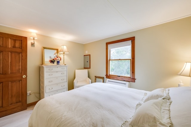 bedroom featuring electric panel and a wall unit AC