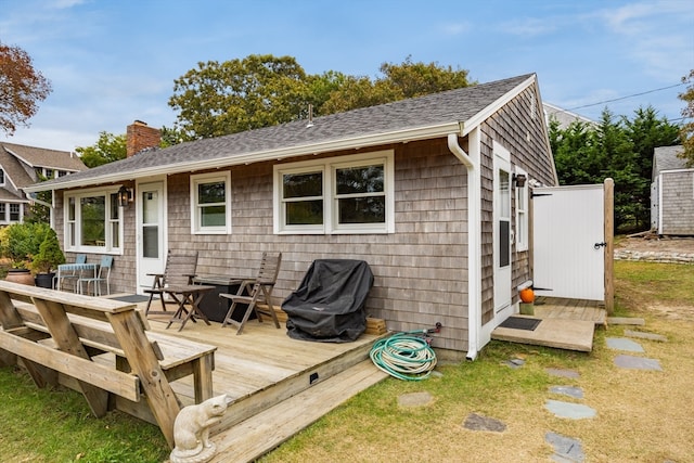 back of house featuring a wooden deck