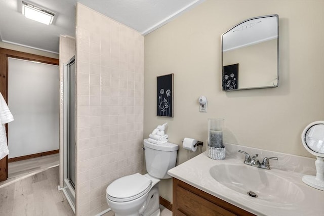 bathroom featuring a shower with door, vanity, hardwood / wood-style floors, and toilet