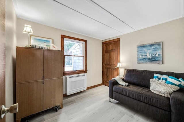 living room featuring radiator and light hardwood / wood-style flooring