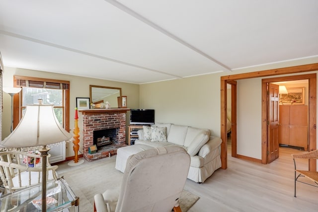 living room with a fireplace and light hardwood / wood-style flooring