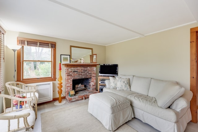 living room with a brick fireplace