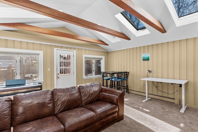 living room with a baseboard radiator, lofted ceiling with skylight, and carpet flooring