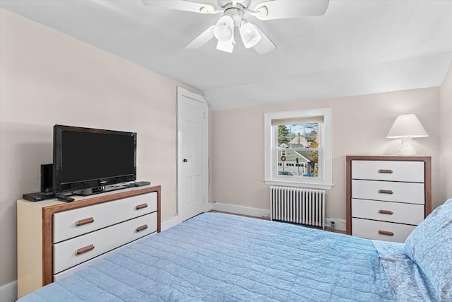 bedroom featuring ceiling fan, radiator heating unit, and lofted ceiling