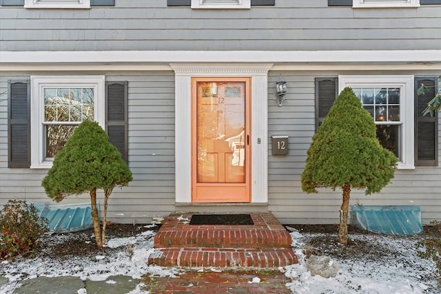 view of snow covered property entrance