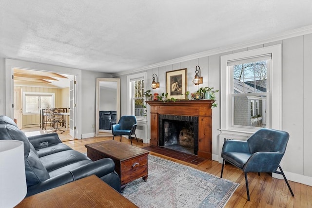 living room featuring wood-type flooring and ornamental molding