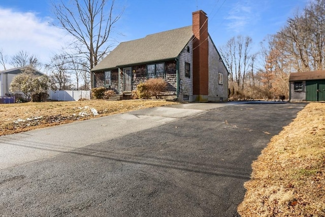 view of side of property with a storage shed