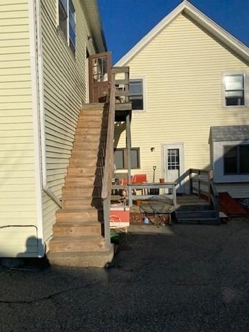 back of property featuring stairs