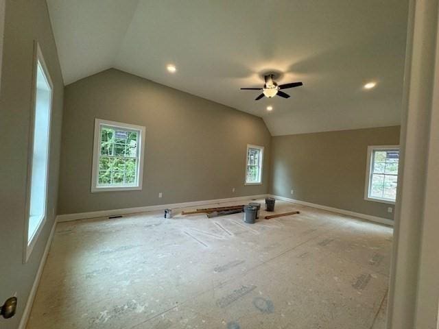 unfurnished room featuring vaulted ceiling, ceiling fan, and baseboards