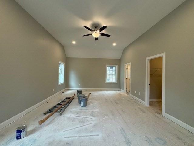 spare room featuring lofted ceiling, ceiling fan, and baseboards