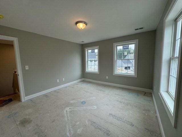 empty room featuring visible vents and baseboards