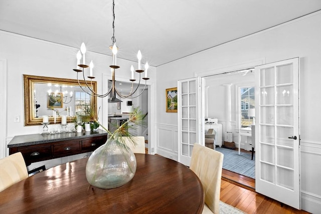 dining room featuring hardwood / wood-style flooring and an inviting chandelier