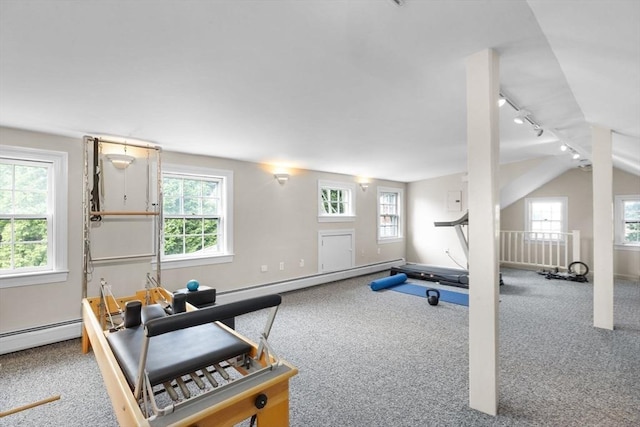 exercise room with carpet floors, a baseboard radiator, lofted ceiling, rail lighting, and baseboards