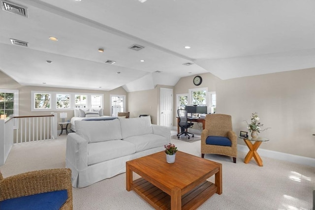 living area with light carpet, visible vents, and vaulted ceiling