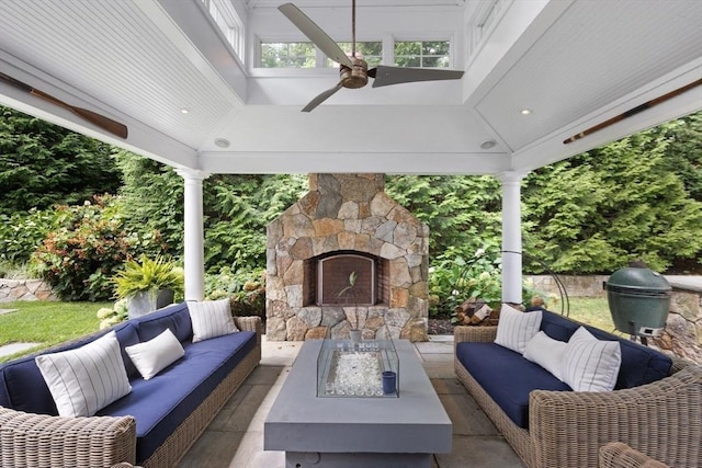 view of patio featuring ceiling fan and an outdoor living space with a fireplace