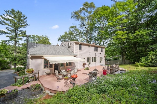 424 Sudbury St, Marlborough, MA 01752 - back of property with a wooden deck, a shingled roof, and a chimney