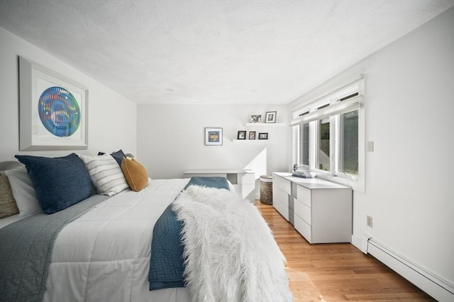424 Sudbury St, Marlborough, MA 01752 - bedroom featuring a baseboard heating unit and light wood-type flooring