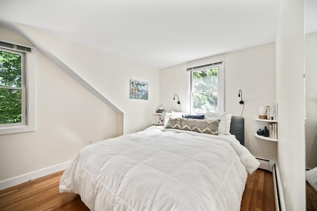 424 Sudbury St, Marlborough, MA 01752 - bedroom featuring multiple windows, wood finished floors, and a baseboard radiator