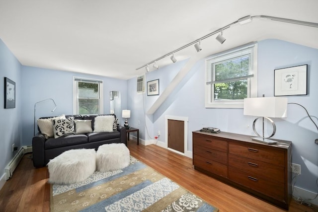 424 Sudbury St, Marlborough, MA 01752 - living room featuring light wood finished floors, baseboard heating, rail lighting, and plenty of natural light