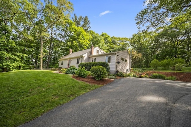 424 Sudbury St, Marlborough, MA 01752 - view of front facade with a front yard, a chimney, and asphalt driveway