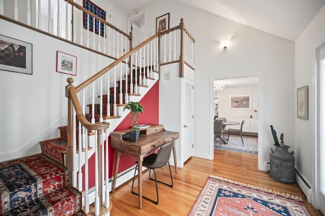 424 Sudbury St, Marlborough, MA 01752 - staircase with wood finished floors, baseboards, baseboard heating, and high vaulted ceiling