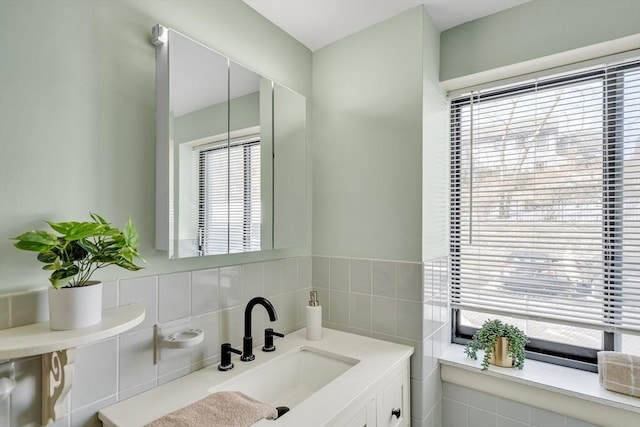 bathroom featuring tile walls and vanity