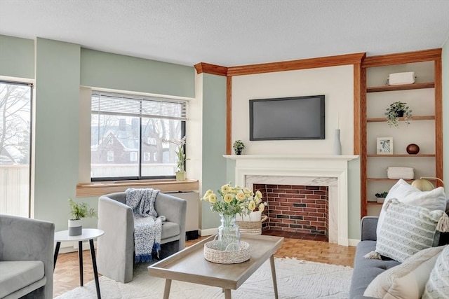 living area featuring a textured ceiling and a high end fireplace