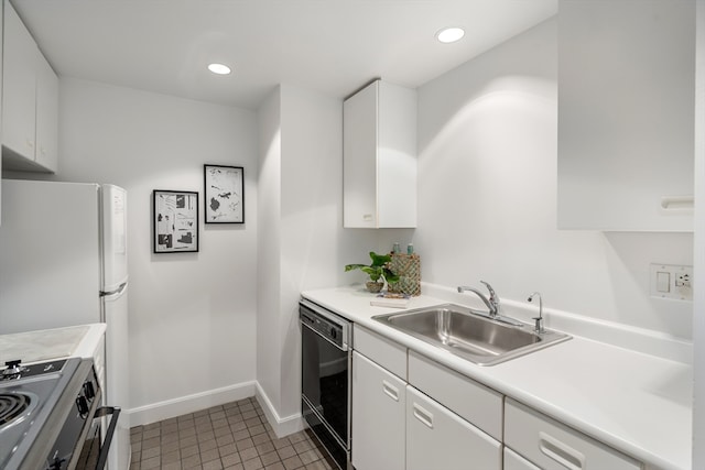 kitchen with stainless steel range oven, dishwasher, white cabinets, and tile patterned floors