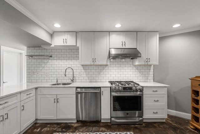 kitchen with stainless steel appliances, white cabinets, a sink, ventilation hood, and baseboards