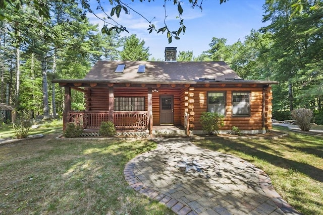 135 Pine St, Rochester, MA 02770 - view of front of home with log siding, a porch, and a front lawn