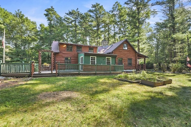 135 Pine St, Rochester, MA 02770 - back of house featuring a garden, a wooden deck, a yard, a chimney, and log exterior