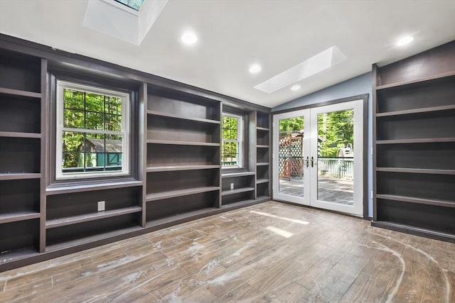 135 Pine St, Rochester, MA 02770 - unfurnished living room with a skylight, vaulted ceiling, wood finished floors, french doors, and built in shelves