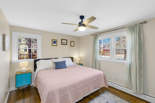 331 Townsend Rd, Groton, MA 01450 - bedroom with baseboard heating, wood finished floors, and ceiling fan