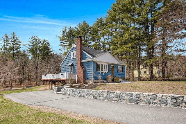 331 Townsend Rd, Groton, MA 01450 - view of home's exterior featuring a deck, a chimney, a lawn, and asphalt driveway