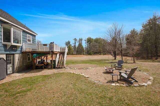 331 Townsend Rd, Groton, MA 01450 - view of green lawn with an outdoor fire pit, stairway, and a wooden deck