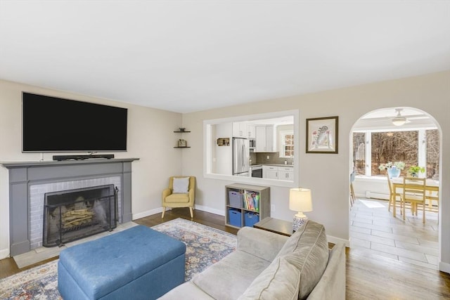 331 Townsend Rd, Groton, MA 01450 - living room with a fireplace, ceiling fan, and wood finished floors