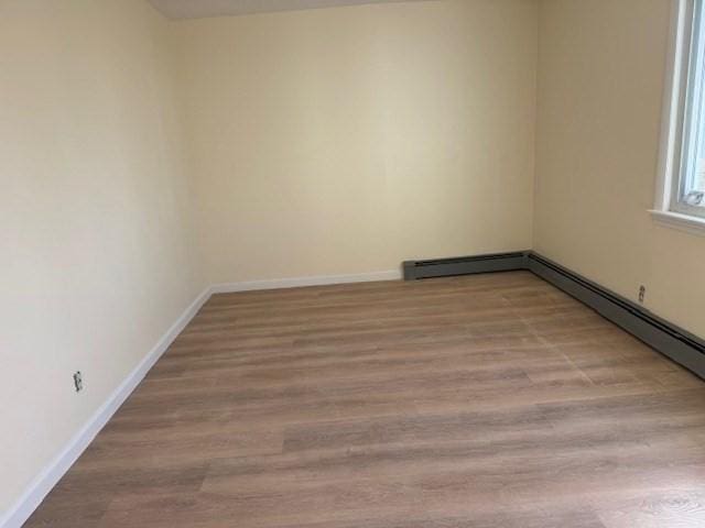 61 Belleville Rd, New Bedford, MA 02745 - spare room with a baseboard radiator, wood finished floors, and baseboards