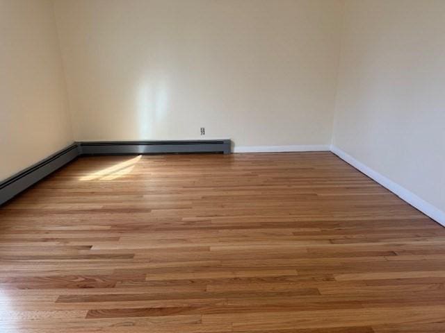 61 Belleville Rd, New Bedford, MA 02745 - empty room with wood finished floors and baseboards
