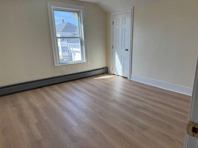 61 Belleville Rd, New Bedford, MA 02745 - additional living space featuring baseboard heating, baseboards, wood finished floors, and vaulted ceiling