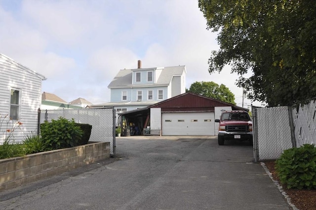 61 Belleville Rd, New Bedford, MA 02745 - view of front of home featuring fence, an outdoor structure, a chimney, and a detached garage