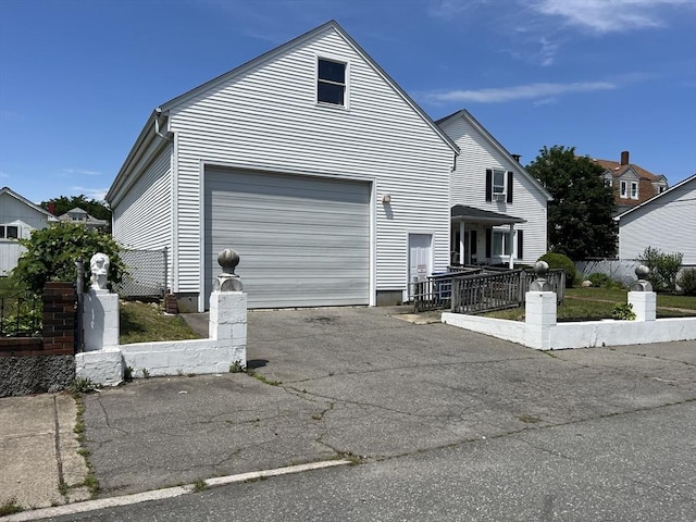 61 Belleville Rd, New Bedford, MA 02745 - view of front of house with a garage, fence, and driveway