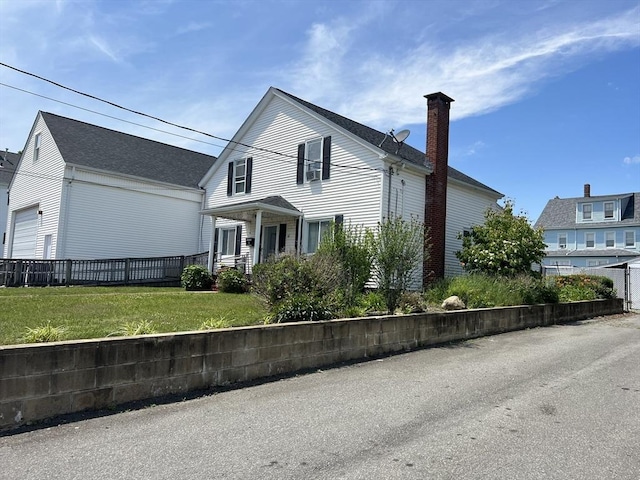 61 Belleville Rd, New Bedford, MA 02745 - traditional-style house featuring a front yard, fence, a garage, and a chimney