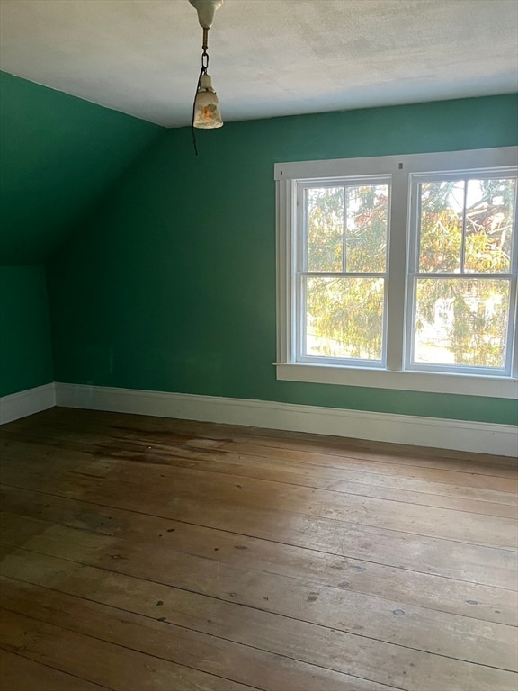 bonus room featuring hardwood / wood-style flooring and vaulted ceiling