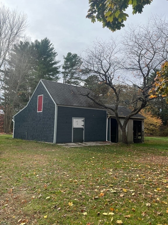 view of outbuilding featuring a yard