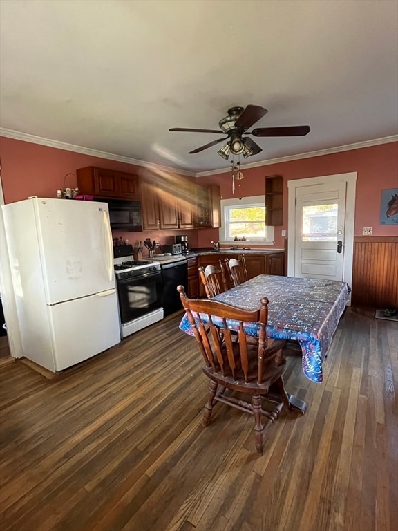 kitchen with dark hardwood / wood-style flooring, black appliances, ceiling fan, and crown molding