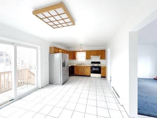 kitchen with stainless steel fridge with ice dispenser, light countertops, brown cabinets, electric range, and a sink