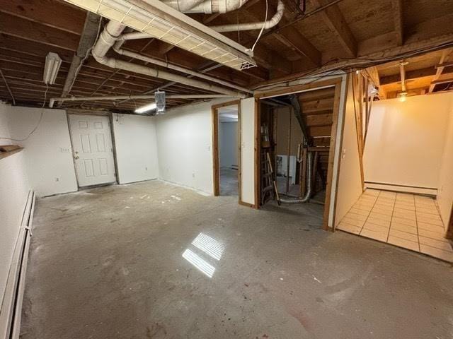 unfinished basement with a baseboard heating unit