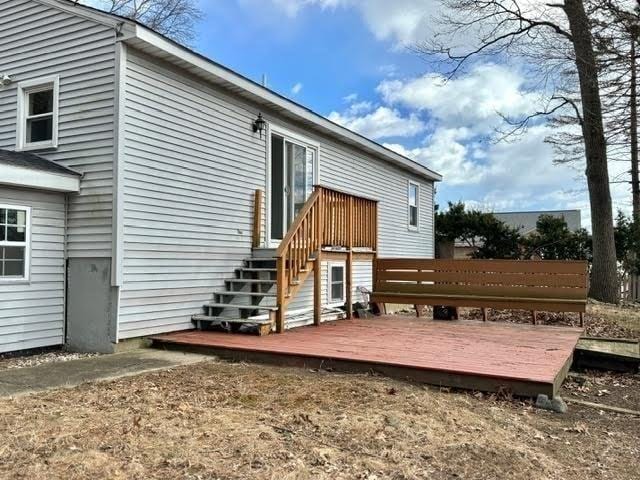 rear view of property featuring a deck