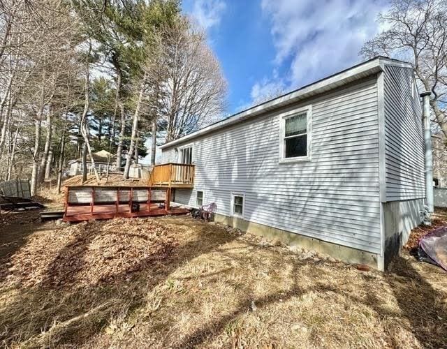 view of home's exterior with a wooden deck