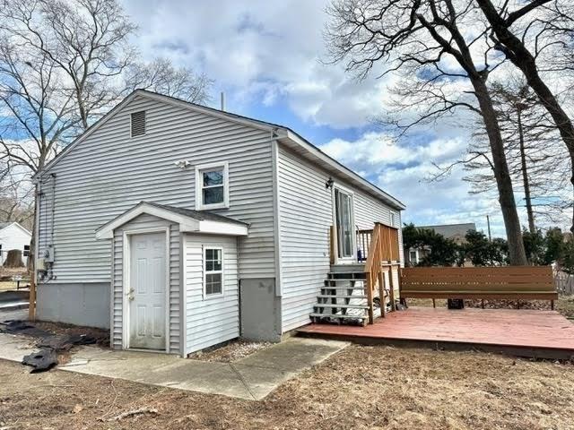 rear view of property with a wooden deck